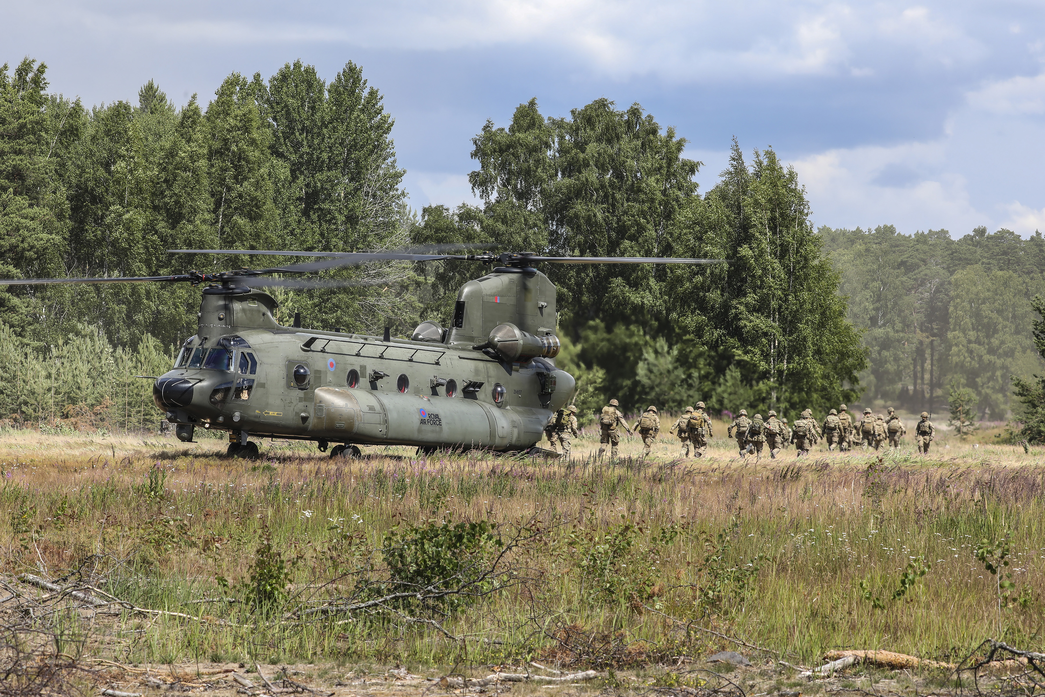 Image shows RAF Regiment aviators leaving a RAF Chinook in Estonia.